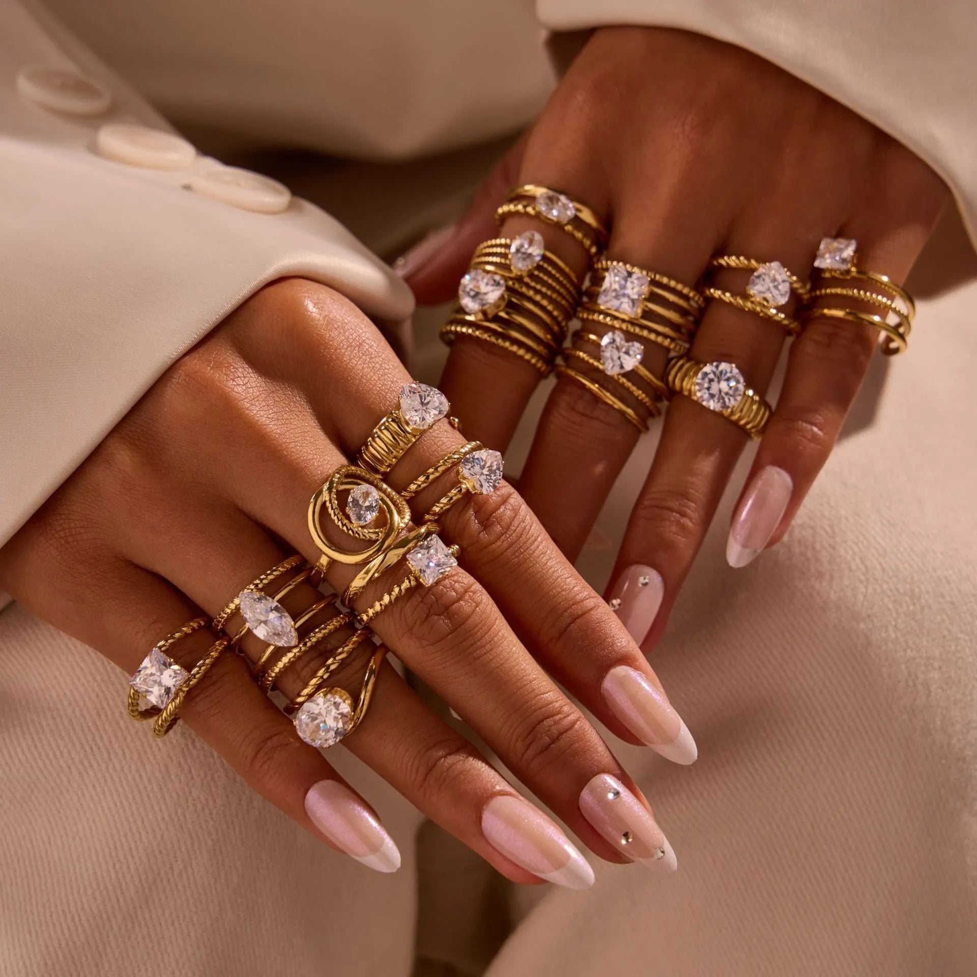 Gold electroplated adjustable ring with geometric zircon design on a stainless steel band.
