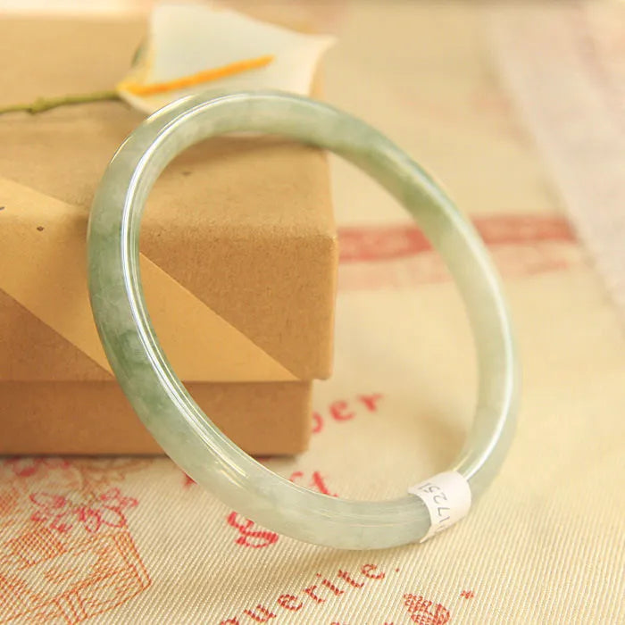 Green jade geometric bracelet with waxy finish showing 10mm width and Chinese style design