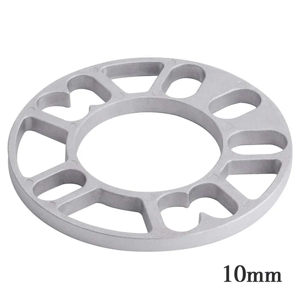 Set of metal hubcentric wheel spacer gaskets in different thicknesses for car brake caliper clearance.