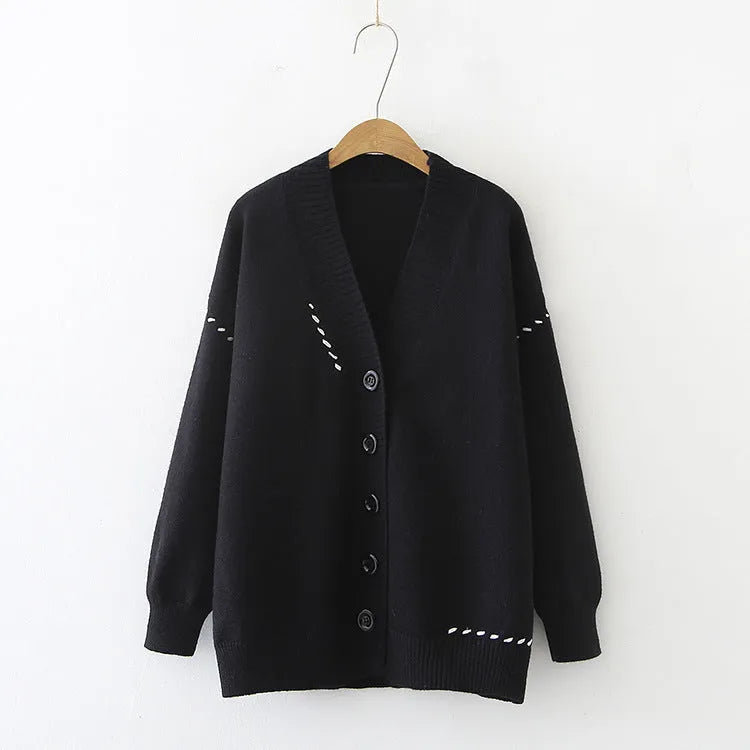 Women's loose-fit knitted cardigan coat in black or white.