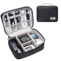 Black waterproof electronics organiser bag open, showing mesh pockets, elastic loops, and removable padded dividers inside.
