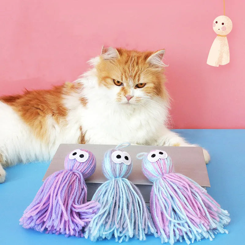 Four wool cat balls with hanging loops and teaser stick in blue grey, pink and blue, and pink purple colours