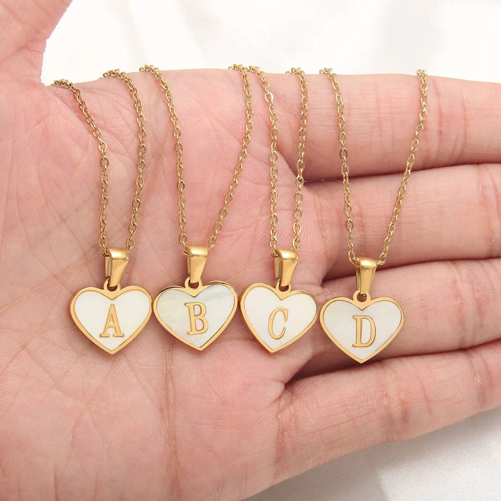 Gold-plated heart necklace with white shell centre and personalised letter pendant on 45cm chain