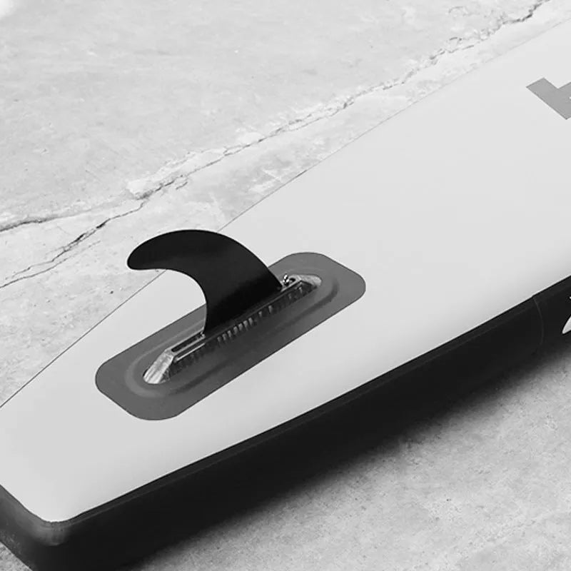 Black plastic SUP paddle with large removable fish fins for water propulsion.