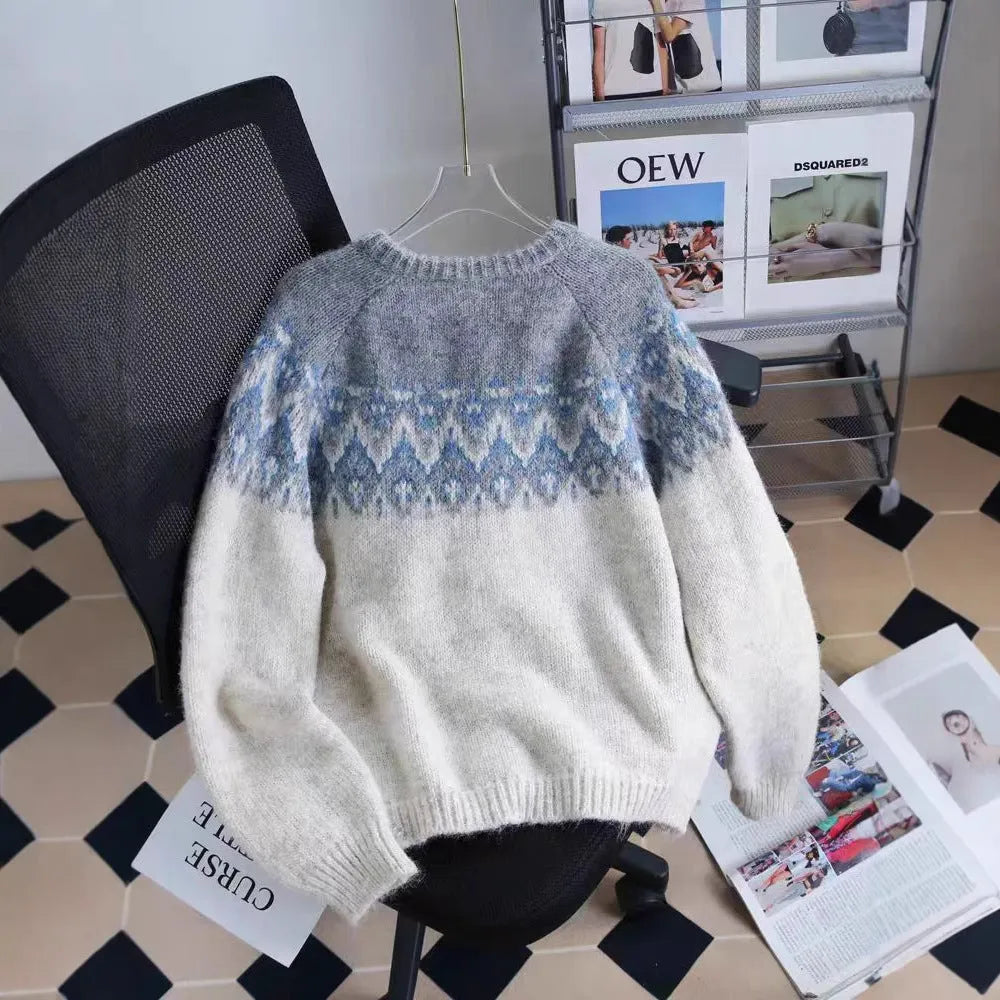 Women's loose fit jacquard knit sweater coat in contrast colours, showing long sleeves and textured pattern.