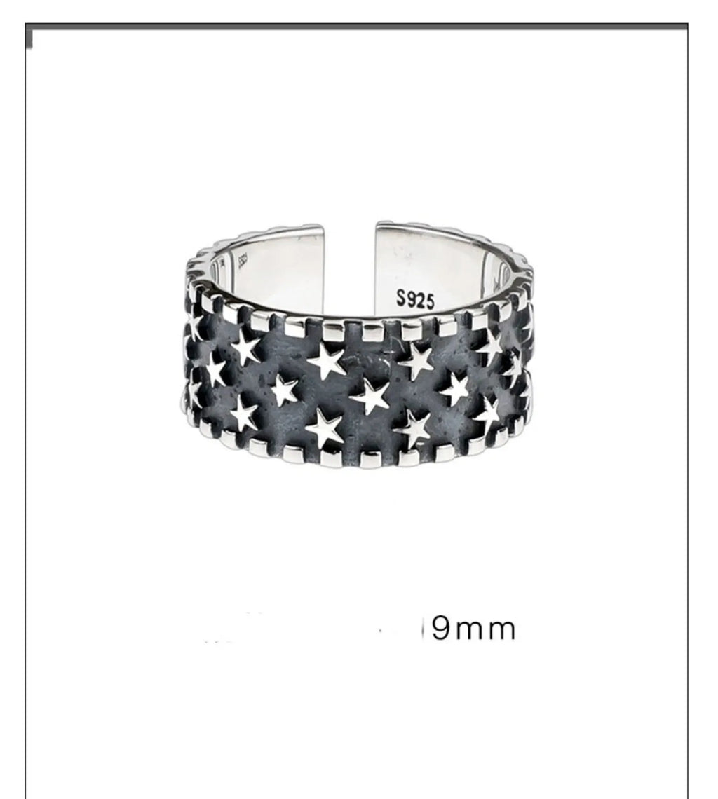 Adjustable open-back sterling silver ring with a geometric five-pointed star pattern.