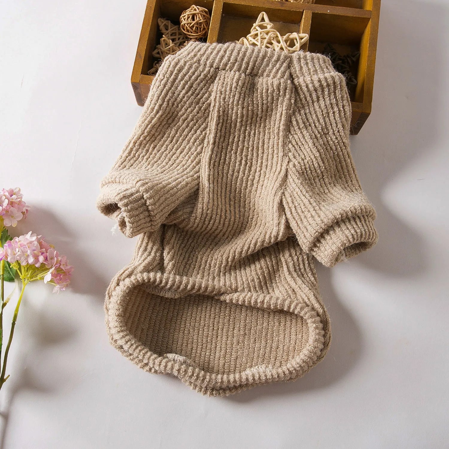 Brown knitted pullover sweater on a small dog, showing casual design and soft fabric.