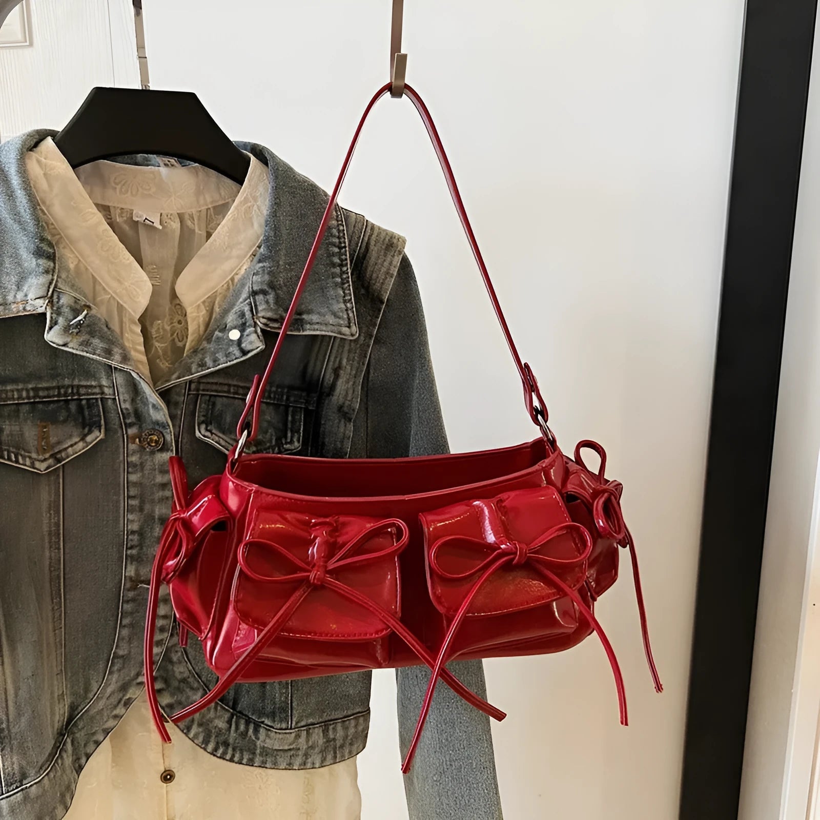 Women's pleated shoulder bag with a tassel bow, shown in multiple colours including apricot and black.