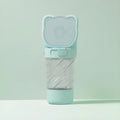 Green, pink, or white 3-in-1 portable pet water bottle with food container and garbage bag dispenser attached to a strap.