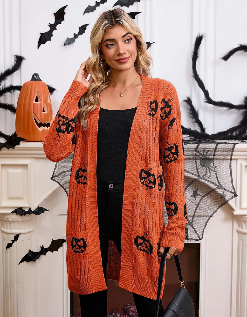 Women's black Halloween cardigan with orange Jacquard-knitted pumpkin head pattern.