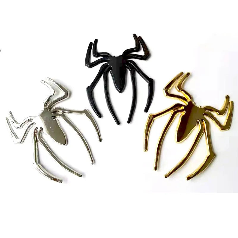 Three-dimensional metal spider car bumper sticker in gold, silver, black, and red colour options.
