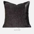 Grey and white plaid bed runner blanket set with a leather round pillow on a modern bed.