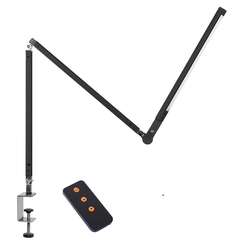Adjustable LED desk lamp with clip attachment in black finish on wooden desk