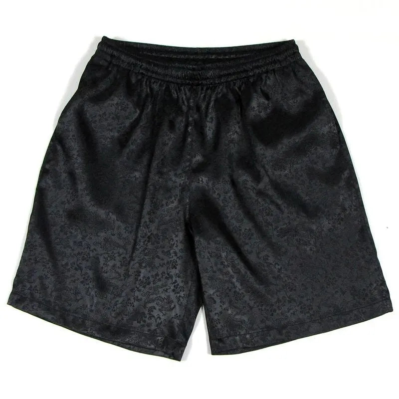 Man wearing traditional black Tang suit style Tai Chi shorts with an elastic drawstring waistband.