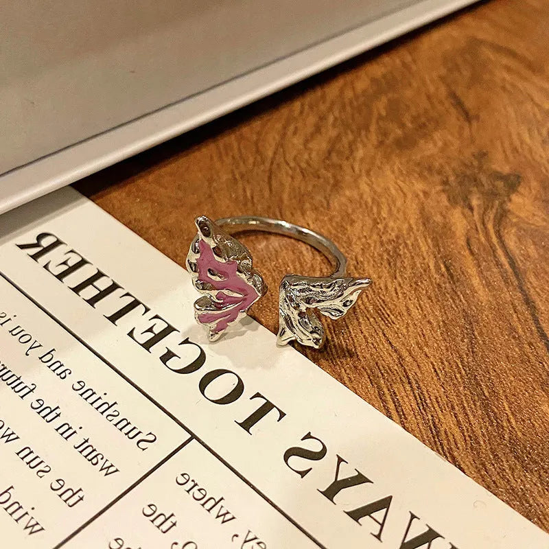 Creative butterfly design women's ring in copper with oil drip finish, showing an open loop style.