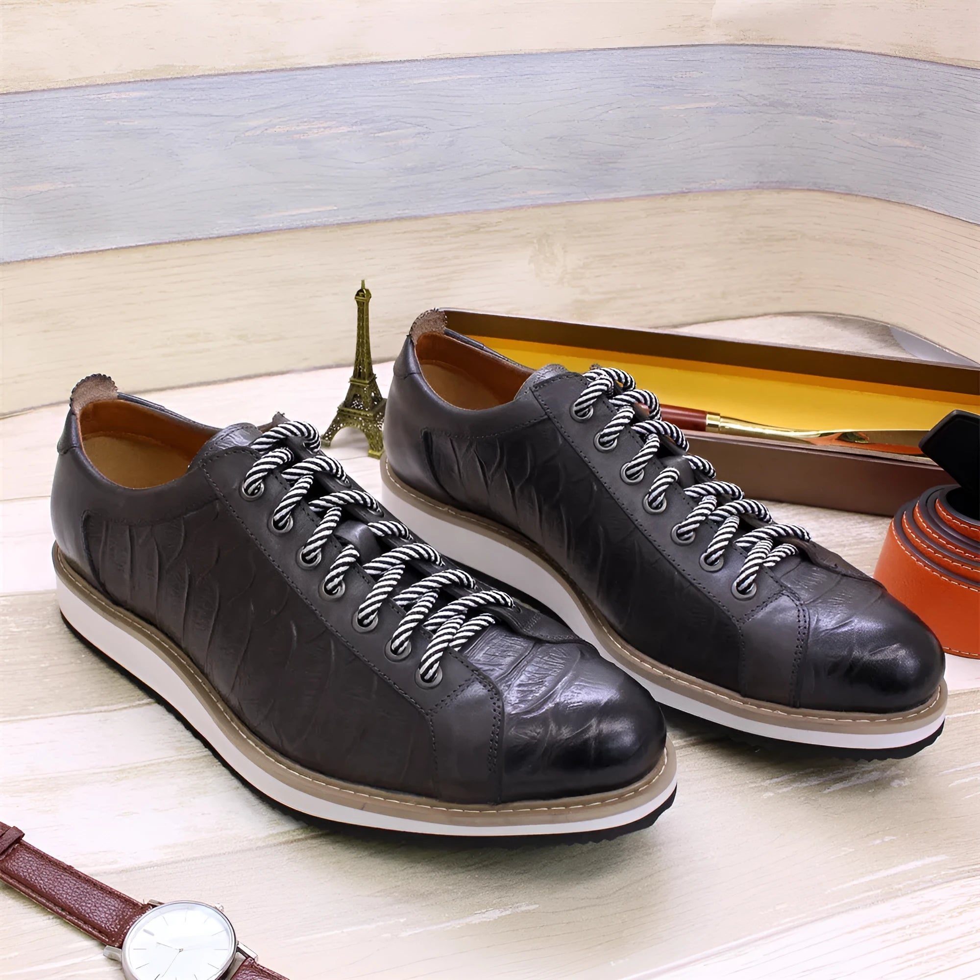 Men's low-top white shoes with embossed pattern texture on the front, featuring front-tie laces.
