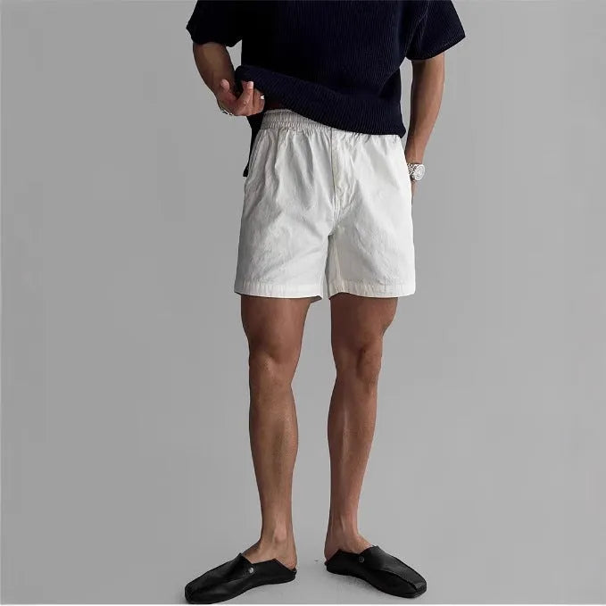 Cotton loose-fit sports shorts in black, shown on a model for summer athletic wear.