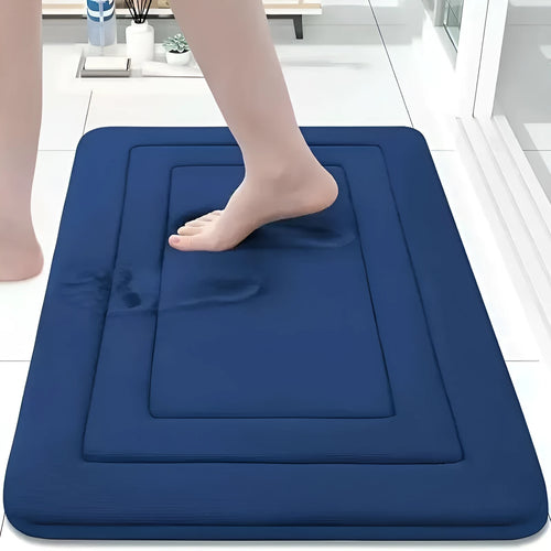 Soft coral velvet bathroom mat with thickened memory foam and anti-slip backing on tiled floor