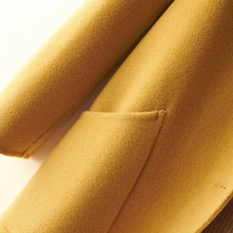 Women's solid colour wool coat with a doll collar and pearl buckle, shown in a mid-length cut.