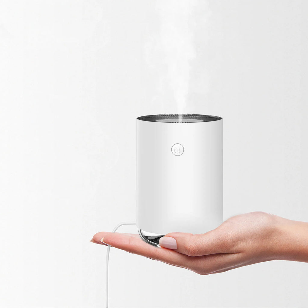 Green USB rechargeable night light humidifier diffuser on table with charging cable