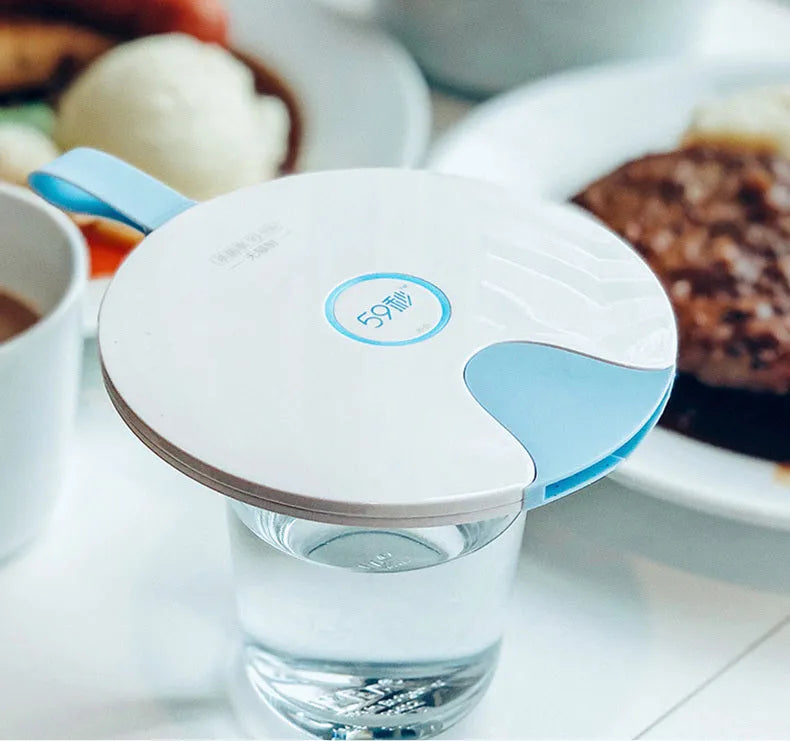 Slim blue portable UV baby bottle steriliser with USB port shown next to a baby bottle.