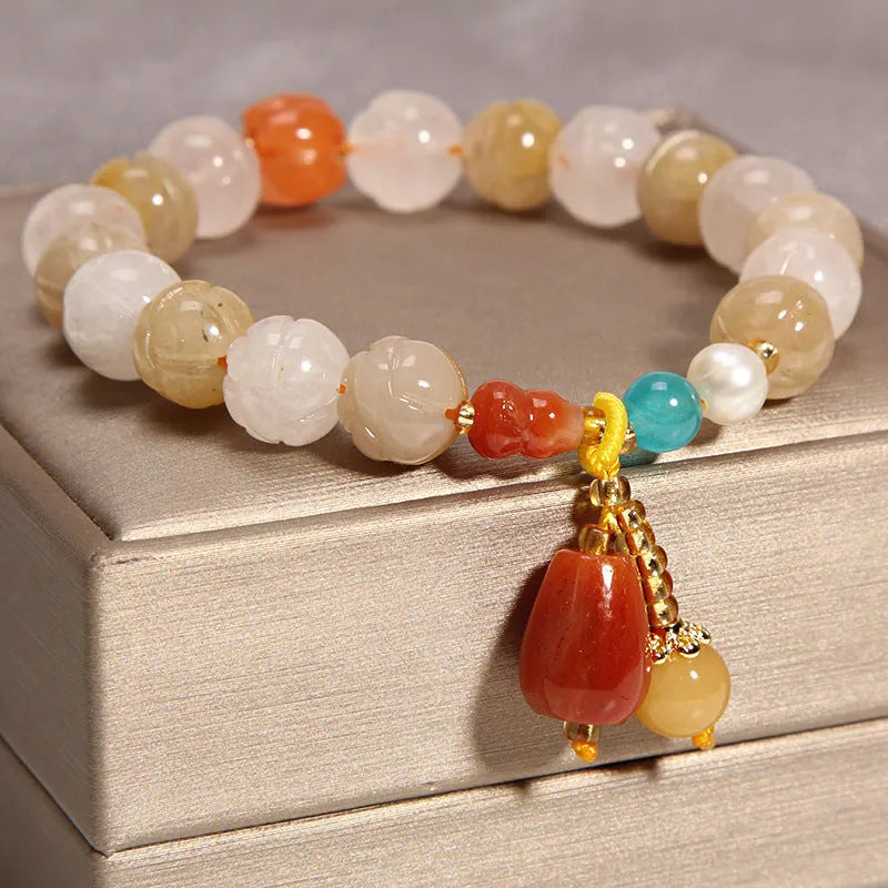 Yellow agate crystal bead bracelet on a gold silk cord with an adjustable metal clasp.