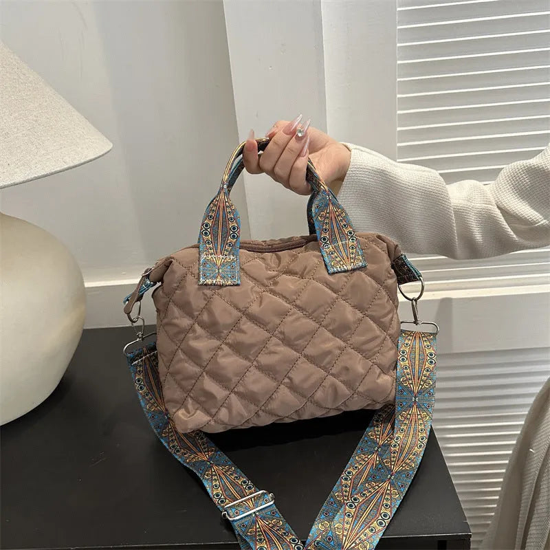 A soft Oxford cloth shoulder messenger bag in a horizontal square shape with embroidery detail.