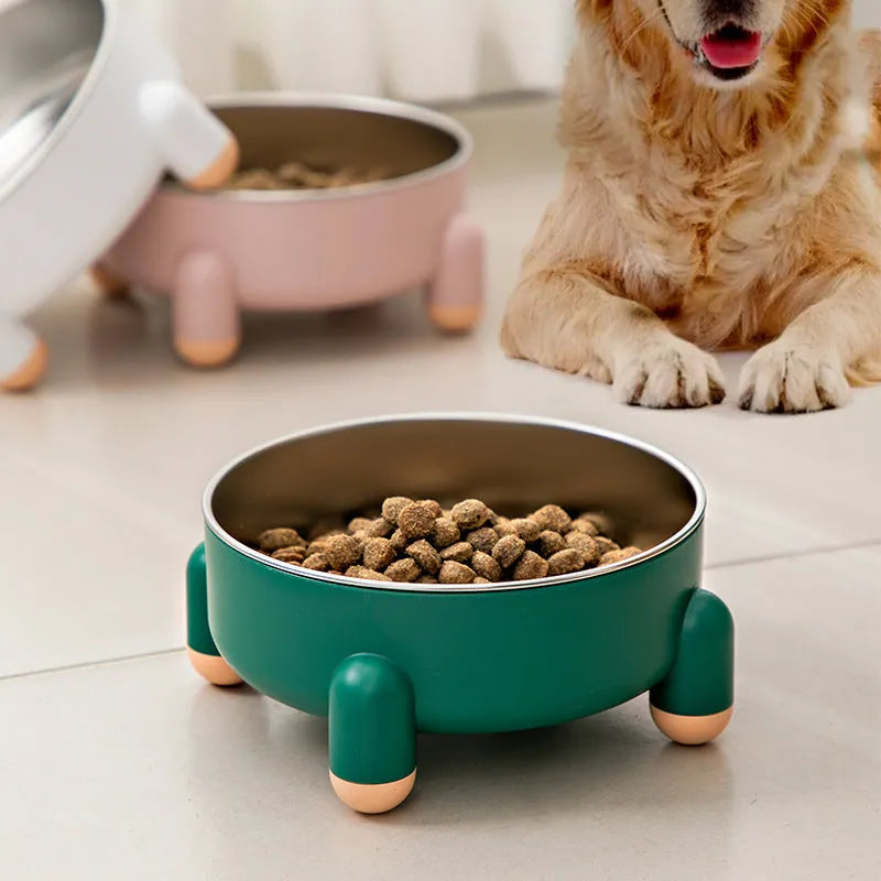 Green non-slip stainless steel pet bowl with high foot base on a floor.