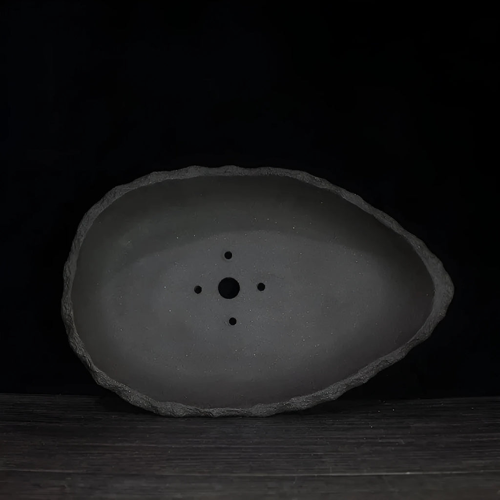 Handmade purple clay flower pot showing natural ceramic texture and floor-standing design