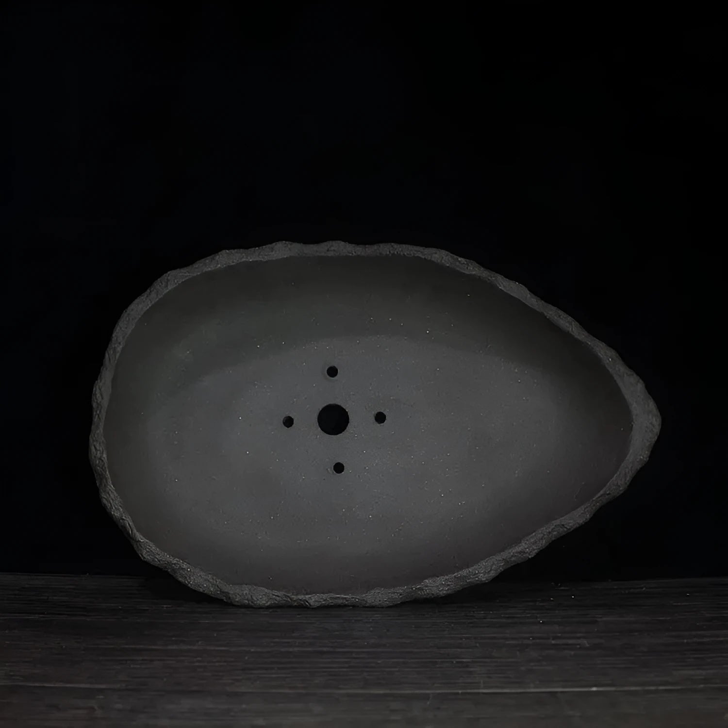 Handmade purple clay flower pot showing natural ceramic texture and floor-standing design