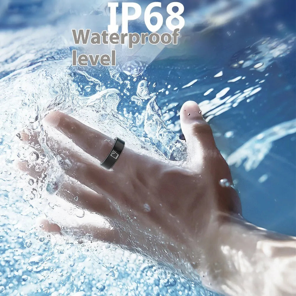 Black ceramic smart ring for health monitoring on a finger, shown with a magnetic charging cable.