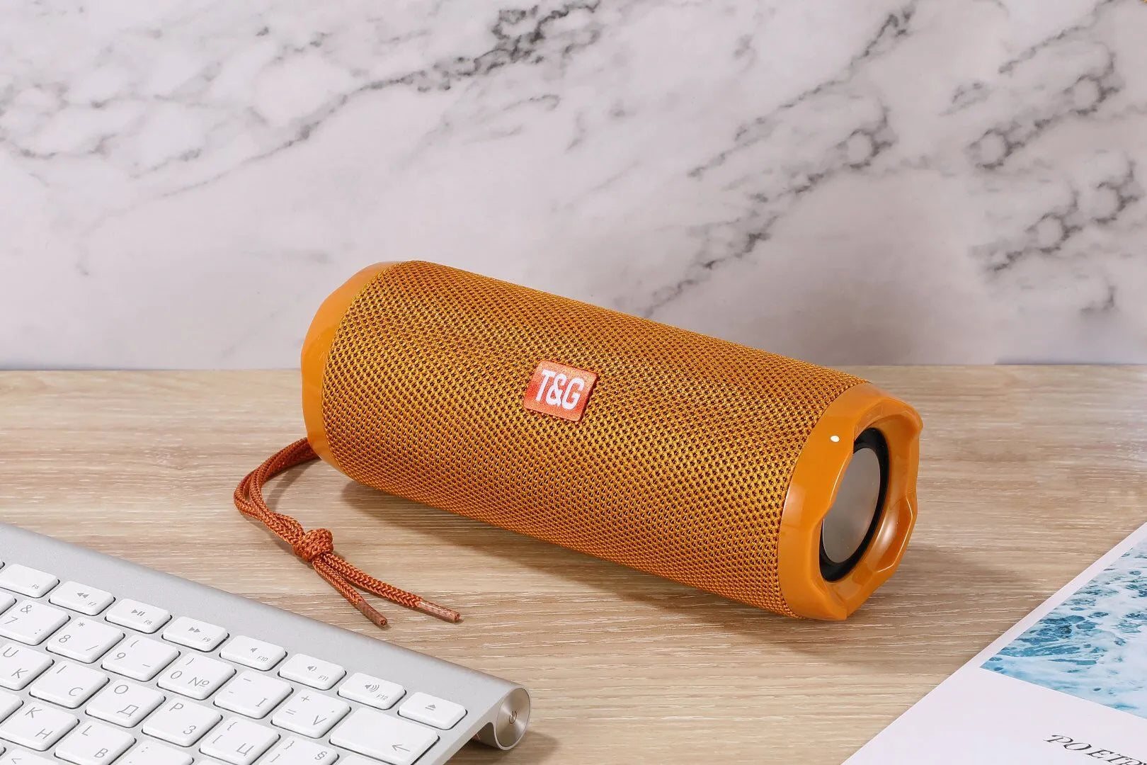 Fabric-covered portable Bluetooth speaker showing the integrated card holder slot, displayed in the camouflage colour variant.