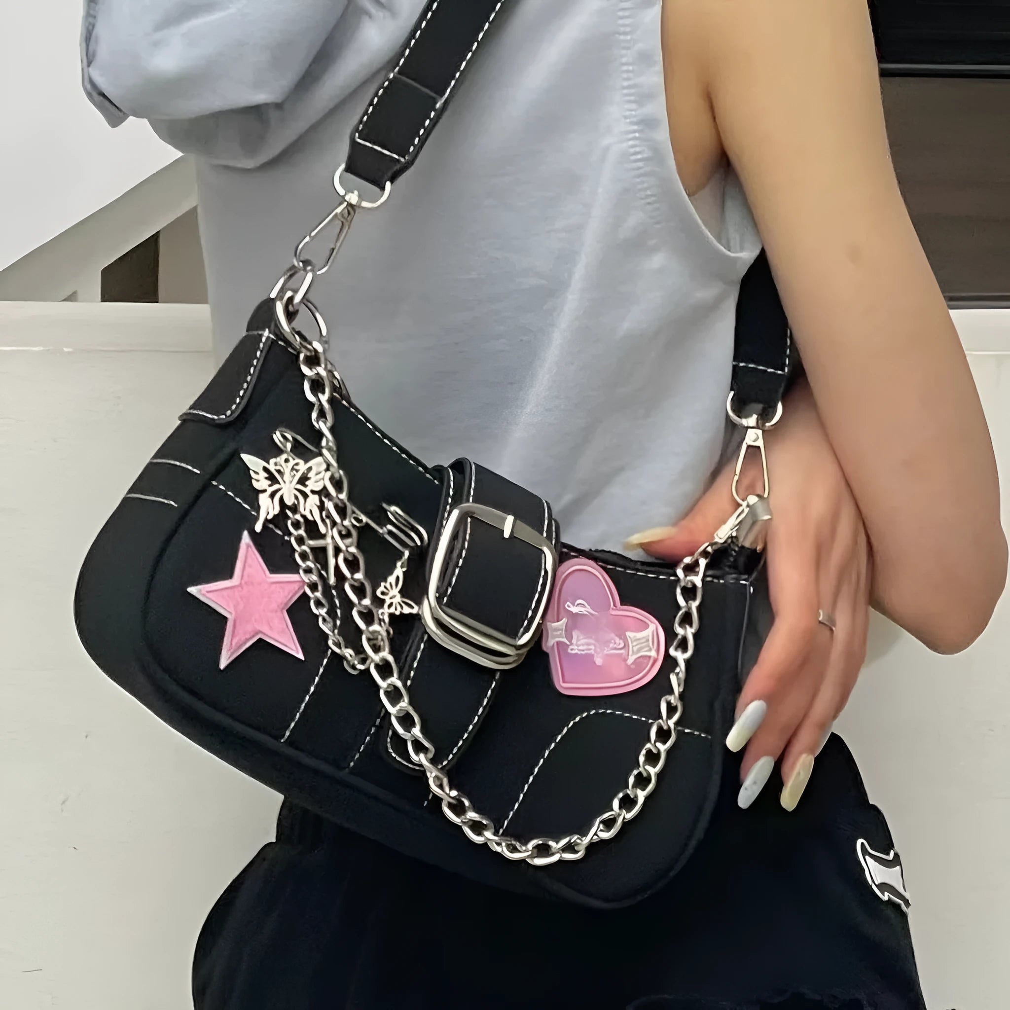 Black PU leather Y2K shoulder bag with heart butterfly shape, bow, stitching, chain, and zipper buckle
