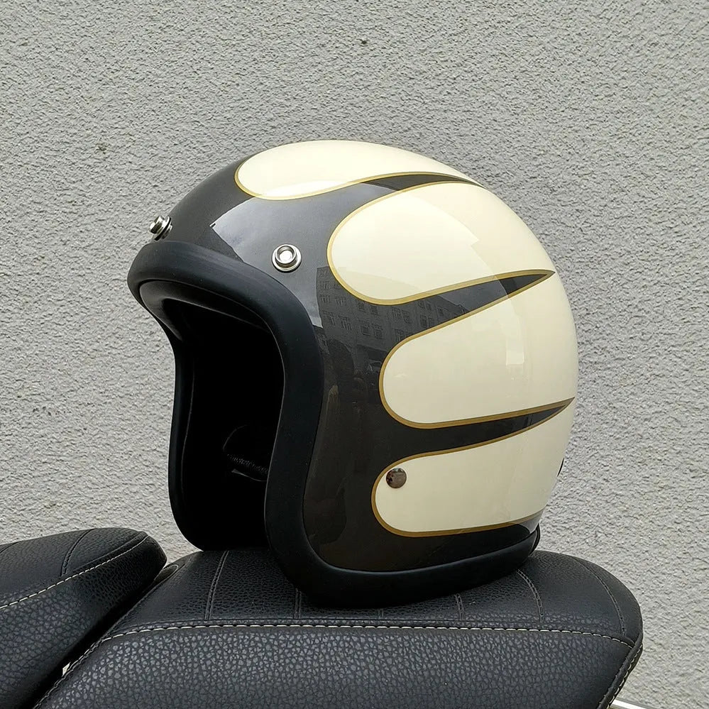 Retro-style open-face motorcycle helmet in fibreglass, shown in a choice of colours including Cement Grey and Matte Black Flower.