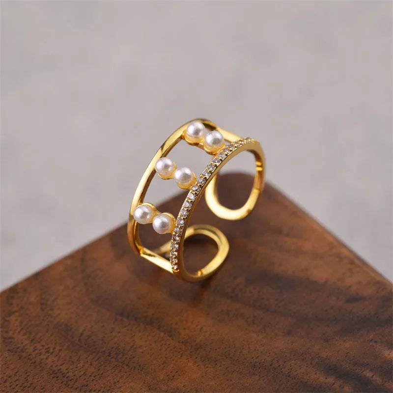 Gold geometric open adjustable ring for women on a white background.