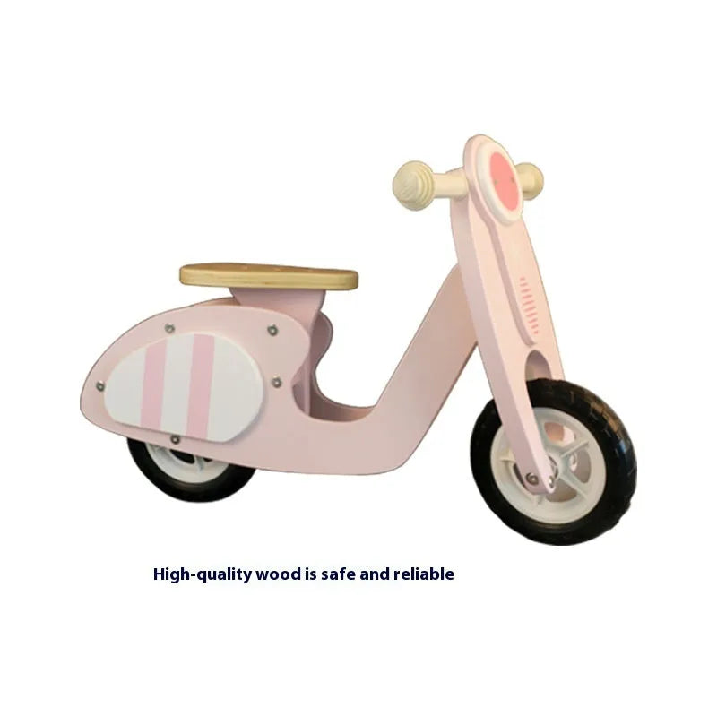 Pink wooden balance scooter for toddlers and children, 10 inches in size.