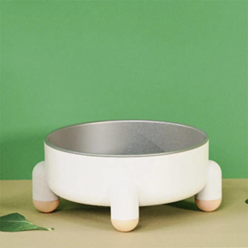 Green non-slip stainless steel pet bowl with high foot base on a floor.