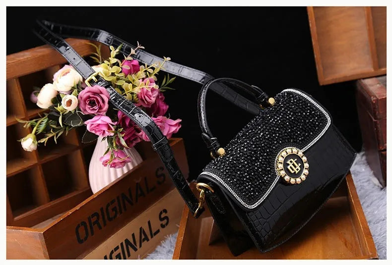 Patent PU diamond shoulder bag in black with oval shape and lock detail, urban simplicity style