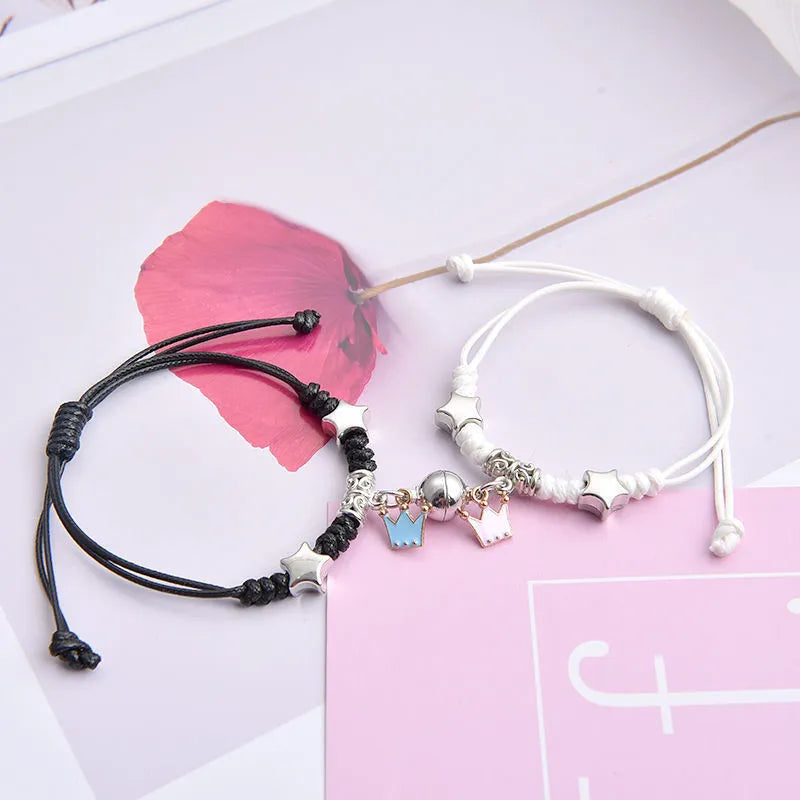 Magnet suction couple bracelets with alloy construction and various pendant designs including crowns and hearts