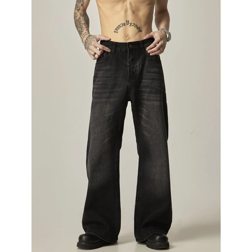 Black loose straight-leg jeans with a retro light wash and zip fly closure laid flat.