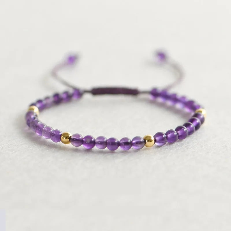 Simple geometric women's bracelet with natural freshwater pearls and crystal details on an elastic rope band.