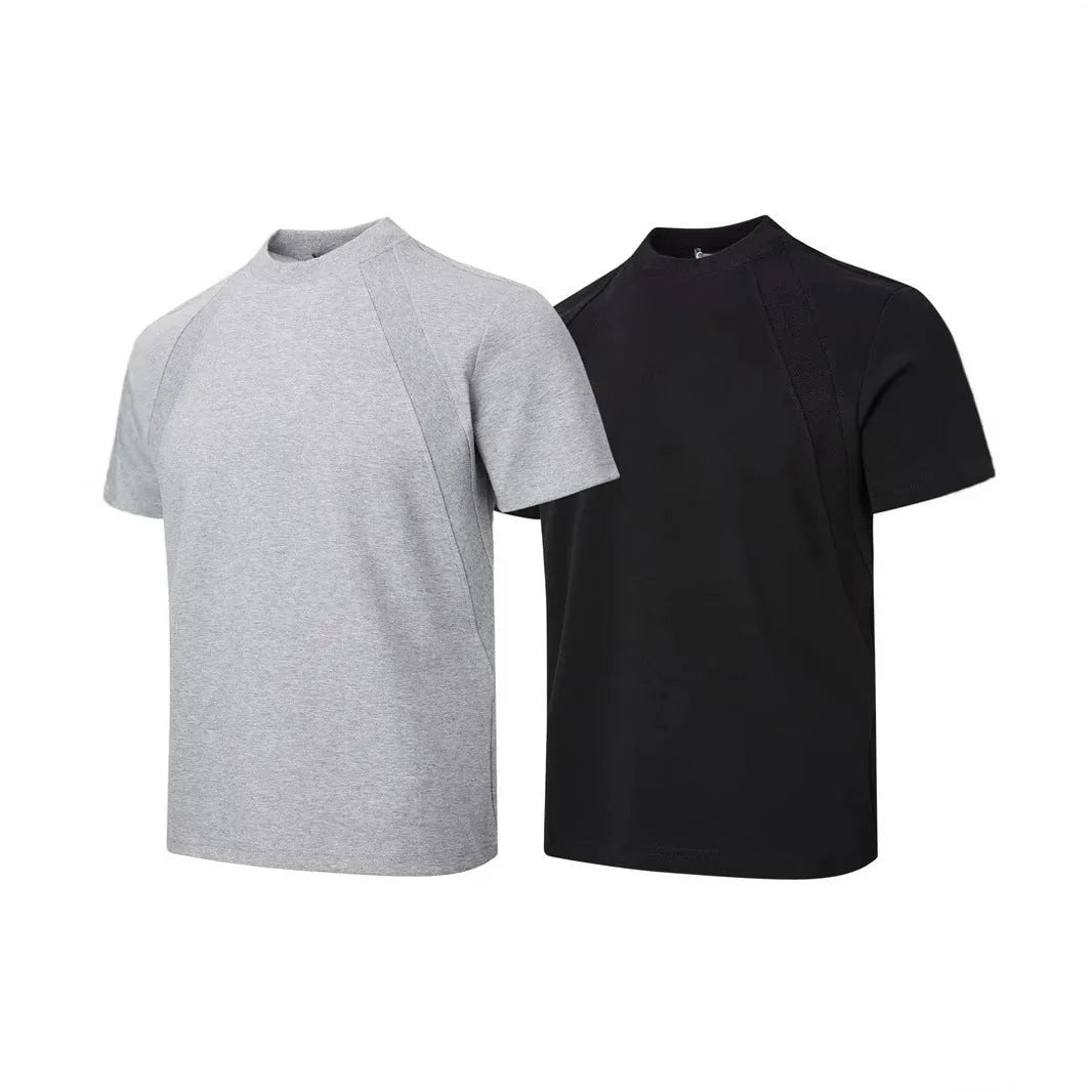 Men's loose fit short sleeve top in black with air layer stitching detail on a grey background.