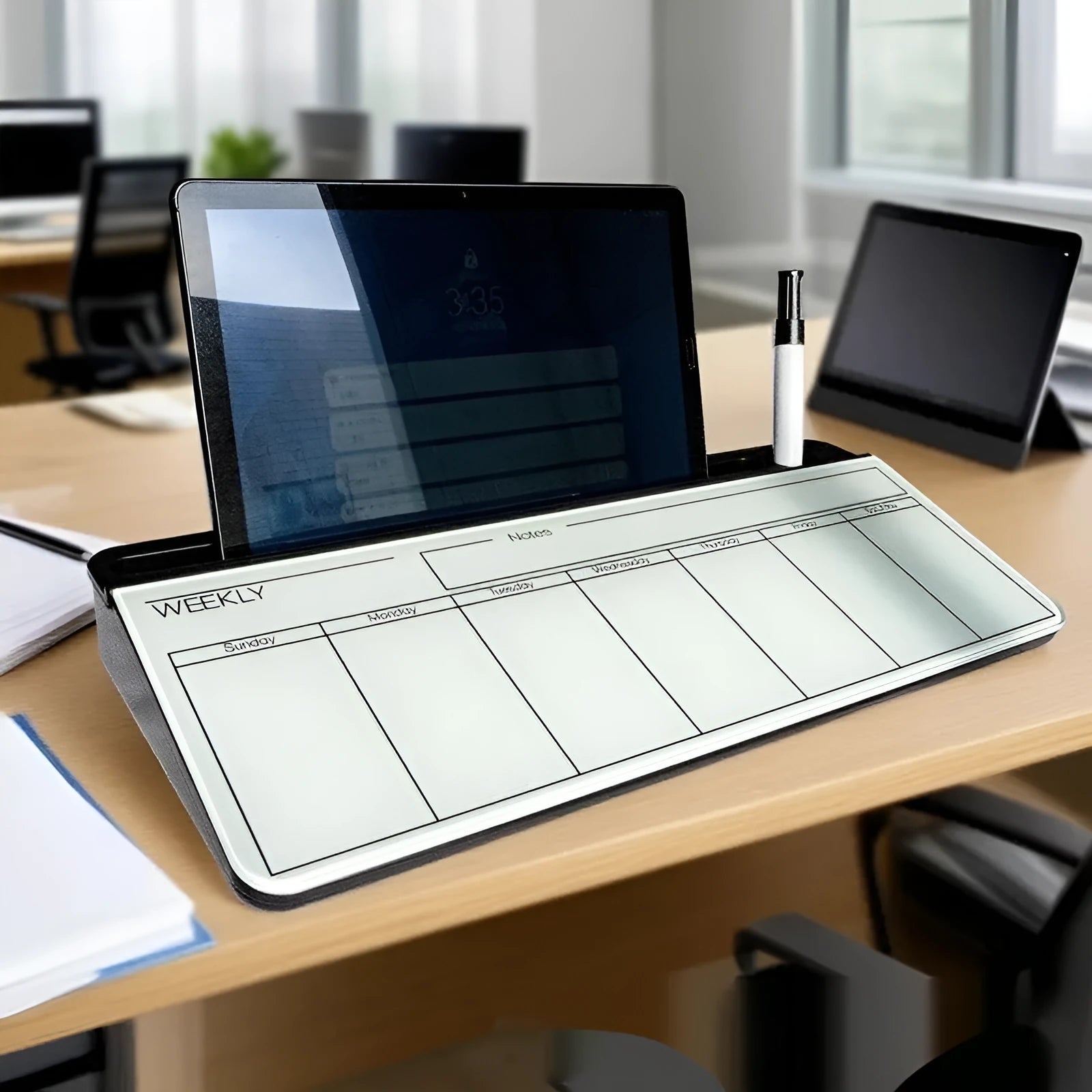 Table top glass whiteboard 18x40cm in black finish on a desk with markers