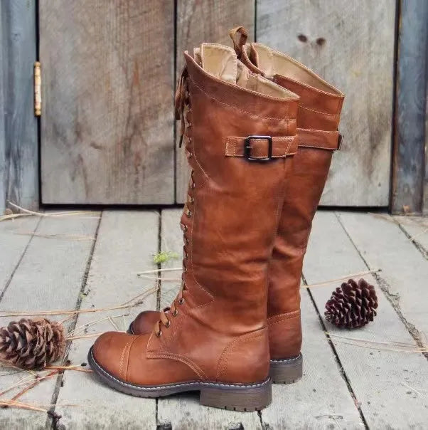 Women's black chunky heel high leg boots with a round toe and low profile.