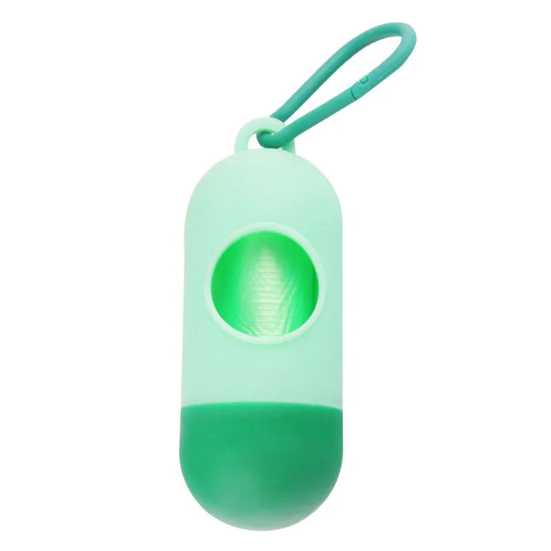 Black plastic dog poop bag dispenser with Velcro strap and a side metal hook.