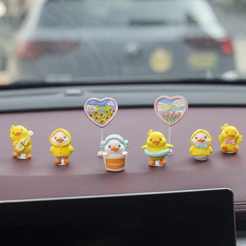 Set of six small PVC cartoon duckling car decorations with hello sign on car dashboard