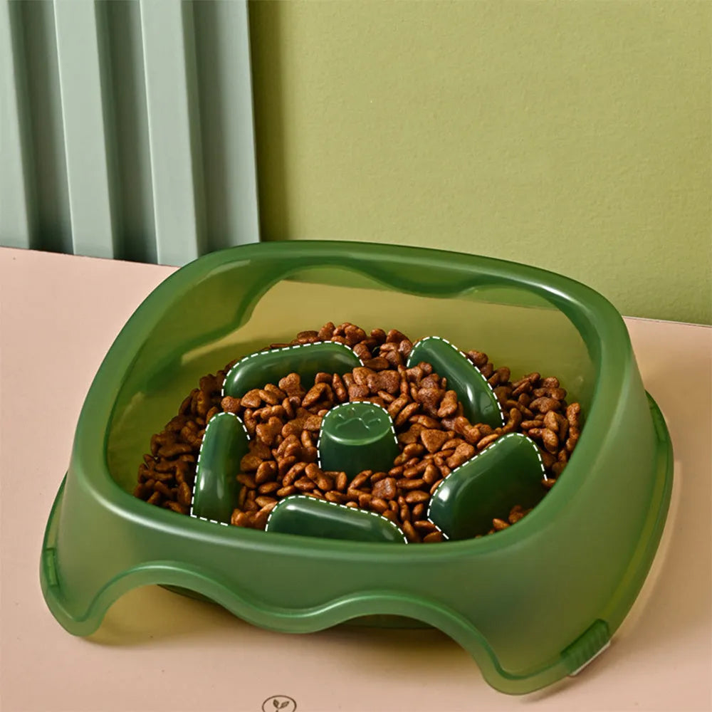 Blue plastic slow-feed dog bowl on a floor to prevent choking.