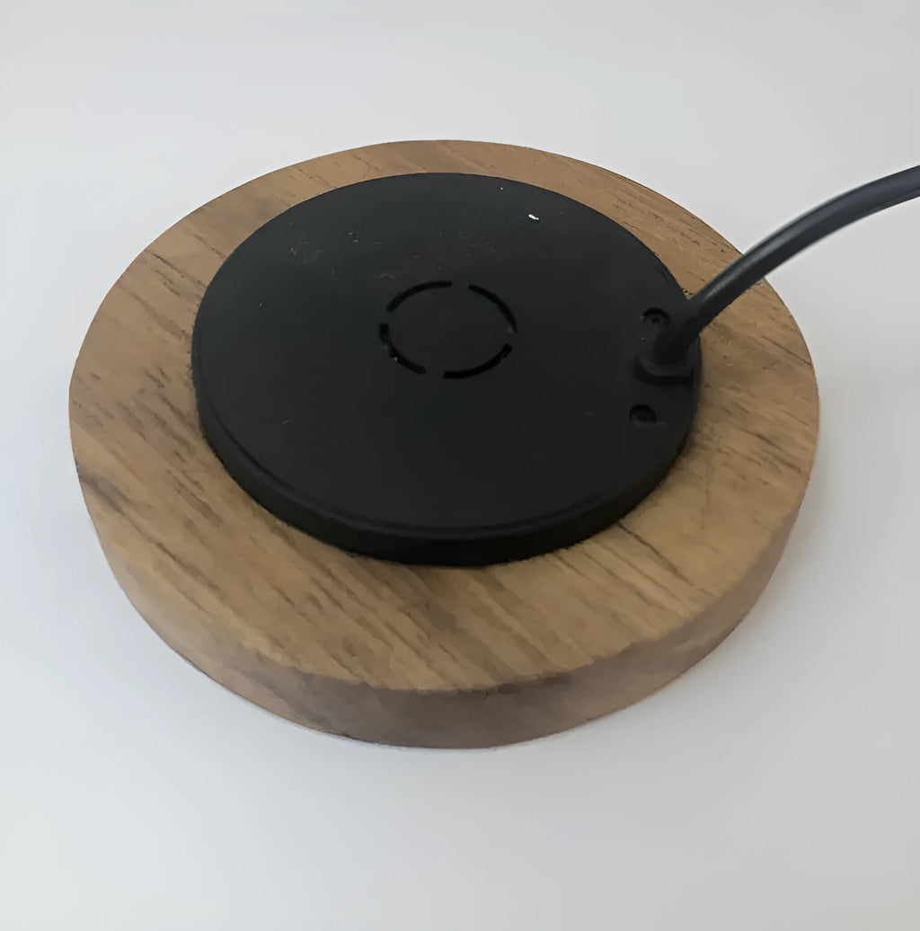 Black 60mm round wireless phone charging pad for furniture installation