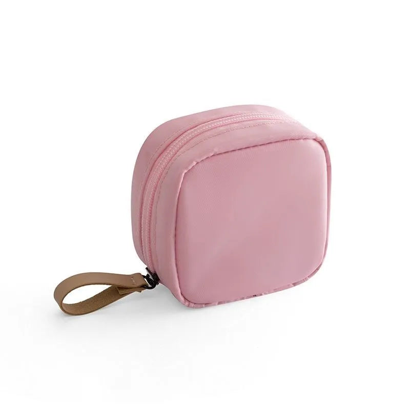 Cube-shaped cloth makeup storage bag in blue, pink, white, and white pink colour options