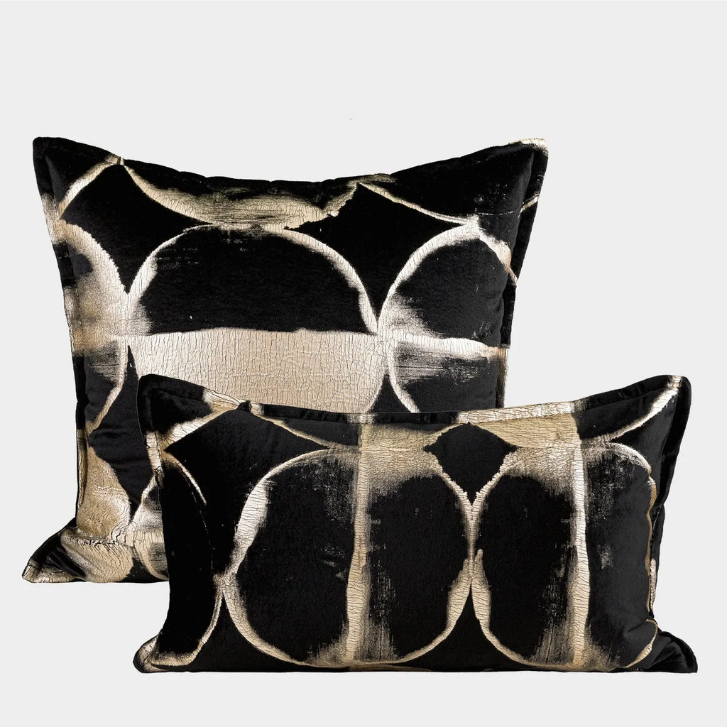 Black and gold abstract pattern flannel cushion cover on a sofa